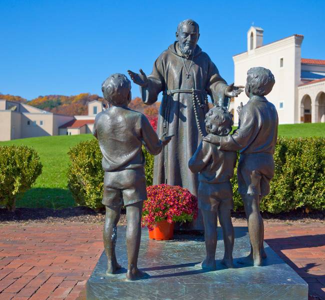 padre pio with children statue